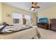 Bright bedroom with ceiling fan and view of the water from the window at 2941 Marlberry Ln, Clermont, FL 34714