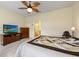 Bright bedroom with wood-look flooring, ceiling fan and stylish furnishings at 2941 Marlberry Ln, Clermont, FL 34714