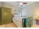Bright bedroom with ceiling fan, patterned quilt, and an olive green wardrobe at 2941 Marlberry Ln, Clermont, FL 34714