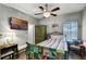 Comfortable bedroom featuring a ceiling fan, a cozy bed, and a wall-mounted TV at 2941 Marlberry Ln, Clermont, FL 34714