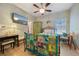Inviting bedroom features a ceiling fan, TV, wood-look floors, and a charming quilt on the comfortable bed at 2941 Marlberry Ln, Clermont, FL 34714