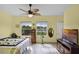 Bright bedroom with view of the water, ceiling fan and wood-look flooring at 2941 Marlberry Ln, Clermont, FL 34714