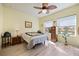 Bright bedroom with view of the water, ceiling fan and wood-look flooring at 2941 Marlberry Ln, Clermont, FL 34714