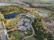 Aerial view showcasing community amenities, including a pool, clubhouse, and lush landscaping at 2941 Marlberry Ln, Clermont, FL 34714