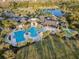 Aerial view highlights the community pool and recreational area, surrounded by lush landscaping at 2941 Marlberry Ln, Clermont, FL 34714