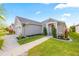 Well-maintained single-story home with manicured landscaping, a two car garage, and a covered entryway at 2941 Marlberry Ln, Clermont, FL 34714