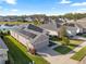 Aerial view of home with solar panels, manicured lawn and landscaping, and a two car garage at 2941 Marlberry Ln, Clermont, FL 34714