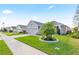 Inviting single-story home with lush landscaping, a two car garage, and a sidewalk at 2941 Marlberry Ln, Clermont, FL 34714