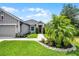 Single-story home with manicured landscaping, a two car garage, sidewalk, and a covered entryway at 2941 Marlberry Ln, Clermont, FL 34714