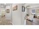 Hallway leading to a living area, featuring wood floors and art at 2941 Marlberry Ln, Clermont, FL 34714