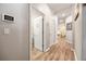 Hallway featuring wood floors, access to laundry room, and neutral wall paint at 2941 Marlberry Ln, Clermont, FL 34714