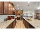 Open kitchen featuring granite countertops, stainless steel appliances, wood cabinets, and an island with sink and dishwasher at 2941 Marlberry Ln, Clermont, FL 34714