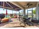 Relax on the lanai with comfortable seating, a dining table, and screened views of the serene backyard pond at 2941 Marlberry Ln, Clermont, FL 34714