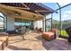 Covered lanai offers a relaxing outdoor space with comfortable seating, dining area, and a retractable awning at 2941 Marlberry Ln, Clermont, FL 34714