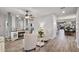 Bright living room featuring wood floors, a fireplace, and stylish furnishings at 2941 Marlberry Ln, Clermont, FL 34714