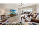 Comfortable living room with wood-look tile floors, ample natural light, and views of the outdoor patio at 2941 Marlberry Ln, Clermont, FL 34714