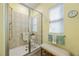 The shower features a glass enclosure, tile surround, shower seat, and a bench at 2941 Marlberry Ln, Clermont, FL 34714