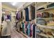 Spacious walk-in closet with custom shelving, ample hanging space, and well-organized storage solutions at 2941 Marlberry Ln, Clermont, FL 34714
