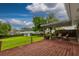 Inviting backyard deck with stylish seating and a tranquil view of the expansive green lawn and vibrant foliage at 3241 Downs Cove Rd, Windermere, FL 34786
