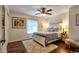 Comfortable bedroom with wood floor, neutral walls, bright window, and stylish accents and decor at 3241 Downs Cove Rd, Windermere, FL 34786