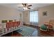 Stylish bedroom with ceiling fan, wood floor, accent rug, side chair, bright window, and fresh decor at 3241 Downs Cove Rd, Windermere, FL 34786