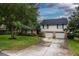 Two-story home with a well-manicured lawn, mature trees, a brick facade, and a convenient two-car garage at 3241 Downs Cove Rd, Windermere, FL 34786