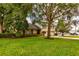 Charming two-story home with manicured lawn and mature trees, showcasing curb appeal and inviting ambiance at 3241 Downs Cove Rd, Windermere, FL 34786