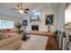 Cozy living room with a fireplace, TV, comfortable seating, and adjacent kitchen bar area at 3241 Downs Cove Rd, Windermere, FL 34786