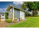 Charming backyard outbuilding with stylish design, complemented by manicured landscaping and lush greenery at 3241 Downs Cove Rd, Windermere, FL 34786