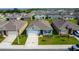 An aerial view of a single-Gathering home with lush landscaping and a well-manicured lawn at 3354 Aruba Way, Haines City, FL 33844