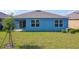 Well-maintained backyard showcasing the home's exterior and landscaping at 3354 Aruba Way, Haines City, FL 33844