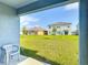 A large backyard with lush green lawn and view of the neighboring houses at 3354 Aruba Way, Haines City, FL 33844