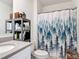 Well-lit bathroom showcasing a granite countertop, toilet, and a decorative tree-themed shower curtain at 3354 Aruba Way, Haines City, FL 33844