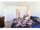 Comfortable bedroom with floral bedding, a dresser, and an ensuite bathroom, offering a relaxing retreat at 3354 Aruba Way, Haines City, FL 33844