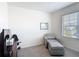 Neutral bedroom design with gray chair and ottoman combo, window for natural light and plush carpet at 3354 Aruba Way, Haines City, FL 33844
