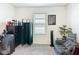 Relaxing bedroom with a dark dresser, window with blinds, and a comfortable seating area at 3354 Aruba Way, Haines City, FL 33844