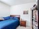 A cozy bedroom shows a wood bed frame and matching nightstand with neutral colored carpet at 3354 Aruba Way, Haines City, FL 33844