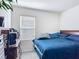 This bedroom features a plush blue comforter and ample natural light from the window at 3354 Aruba Way, Haines City, FL 33844