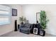 Cozy bedroom featuring a comfortable striped chair with plants and artwork at 3354 Aruba Way, Haines City, FL 33844