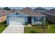 Charming single-Gathering home showcasing a well-manicured lawn and attached two car garage at 3354 Aruba Way, Haines City, FL 33844