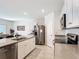 Modern kitchen with stainless steel appliances, an island, and an adjacent dining area at 3354 Aruba Way, Haines City, FL 33844