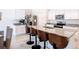 Spacious kitchen island with barstools, stainless steel appliances, and white cabinets at 3354 Aruba Way, Haines City, FL 33844