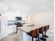 Bright, modern kitchen features an island with bar seating and stainless steel appliances at 3354 Aruba Way, Haines City, FL 33844
