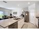 Modern kitchen with stainless steel appliances, an island, and an adjacent dining area at 3354 Aruba Way, Haines City, FL 33844