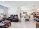 Open-concept living room with leather seating, dining table, and modern kitchen at 3354 Aruba Way, Haines City, FL 33844