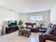 Inviting living room with leather reclining sofas, large TV, and stylish decor, perfect for relaxation at 3354 Aruba Way, Haines City, FL 33844