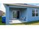 A covered patio with outdoor seating and easy access to the lawn at 3354 Aruba Way, Haines City, FL 33844