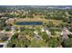 Wide aerial shot of a quiet neighborhood featuring houses backing onto a pond and wooded areas at 3840 Caledonia Ave, Apopka, FL 32712