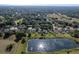 Expansive aerial view of the community showcasing homes, a serene pond, and lush green landscapes at 3840 Caledonia Ave, Apopka, FL 32712