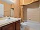 Traditional bathroom featuring vanity sink and a shower-tub combo with tile surround at 3840 Caledonia Ave, Apopka, FL 32712